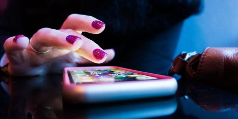 woman hand choosing investment tracking app on phone