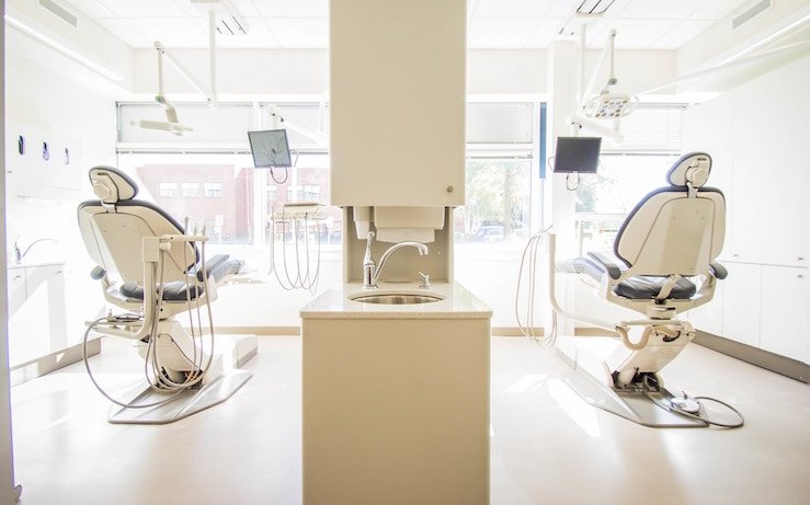 Clean and white dental office with two seats for patients