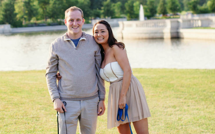 Couple Standing on Grass in front of Lake