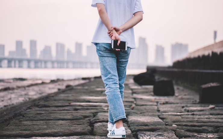 person walking with phone considering a flex job