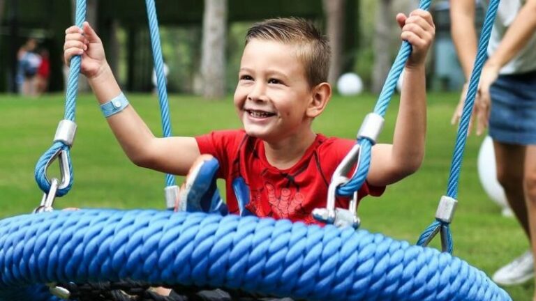 child on outdoor swing